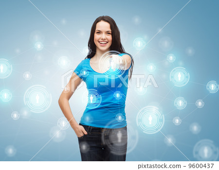 happy girl in t-shirt pointing at social network 9600437