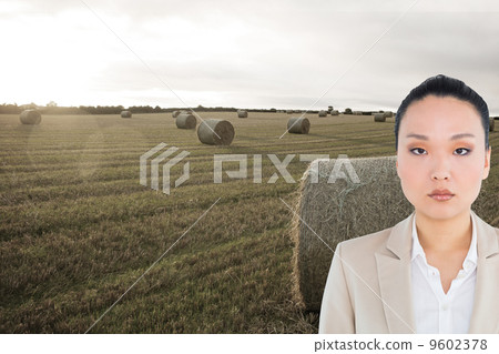 Composite image of unsmiling asian businesswoman 9602378