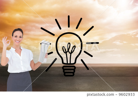 Composite image of stylish businesswoman making gesture while ho Composite image of stylish businesswoman making gesture while ho 9602933