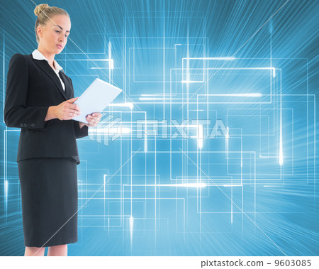 Composite image of businesswoman holding new tablet 9603085