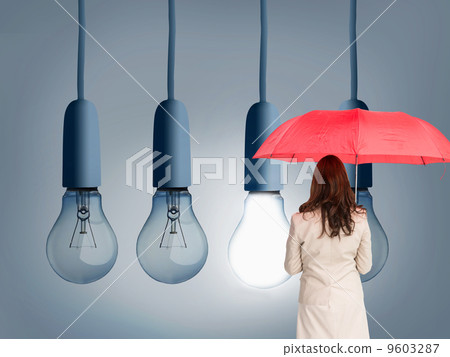Composite image of businesswoman standing back to camera holding Composite image of businesswoman standing back to camera holding 9603287