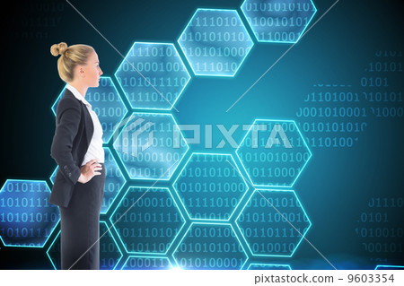 Composite image of businesswoman standing with hands on hips 9603354