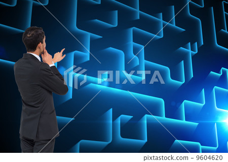 Composite image of thoughtful asian businessman pointing 9604620