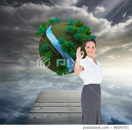 Composite image of elegant businesswoman showing an okay gesture 9604701