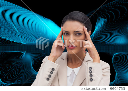 Composite image of young businesswoman putting her fingers on he Composite image of young businesswoman putting her fingers on he 9604733