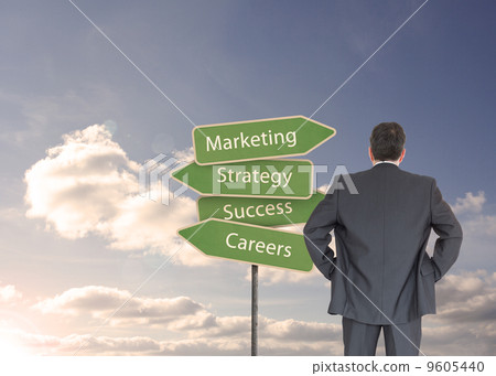Composite image of businessman standing back to the camera with Composite image of businessman standing back to the camera with 9605440