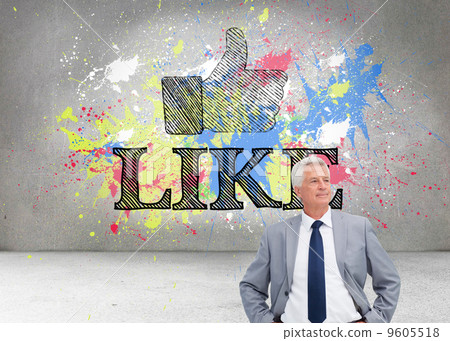 Composite image of man in a suit with his hands on his hips 9605518