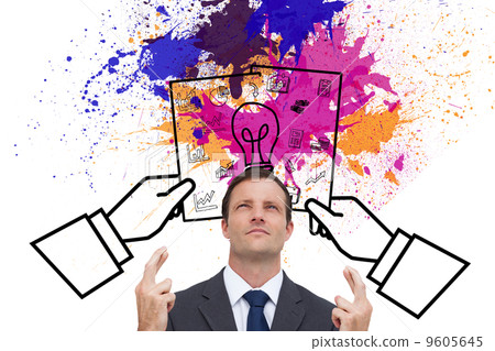 Composite image of serious businessman with fingers crossed is l 9605645