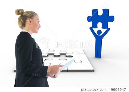 Composite image of businesswoman holding tablet 9605647