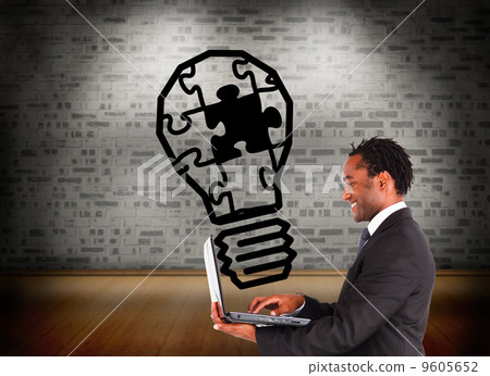 Composite image of businessman working on laptop Composite image of businessman working on laptop 9605652