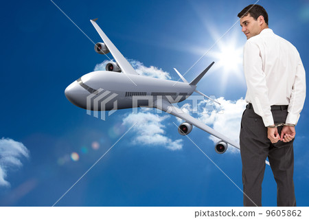 Composite image of businessman wearing handcuffs 9605862