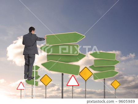 Composite image of businessman standing on ladder 9605989