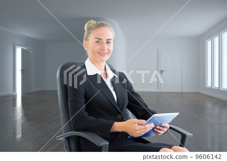 Composite image of businesswoman sitting on swivel chair with ta Composite image of businesswoman sitting on swivel chair with ta 9606142