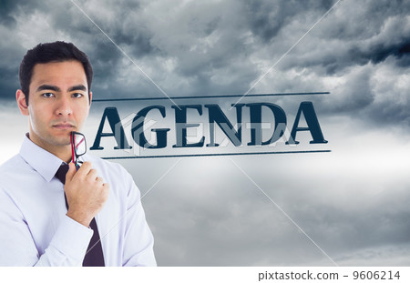 Composite image of unsmiling businessman holding glasses Composite image of unsmiling businessman holding glasses 9606214