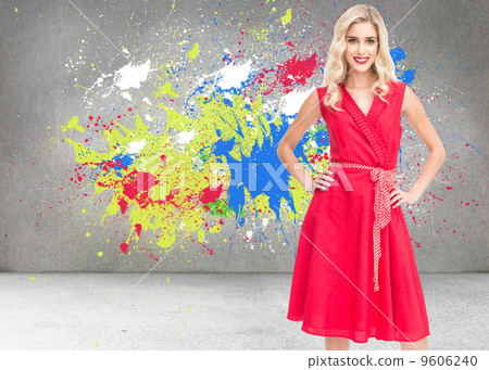Composite image of smiling blonde standing hands on hips 9606240