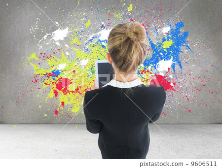 Composite image of businesswoman holding new tablet 9606511