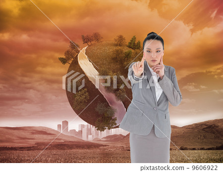 Composite image of thoughtful asian businesswoman pointing 9606922