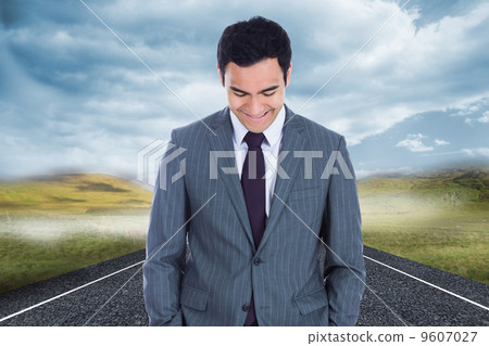 Composite image of smiling businessman standing 9607027