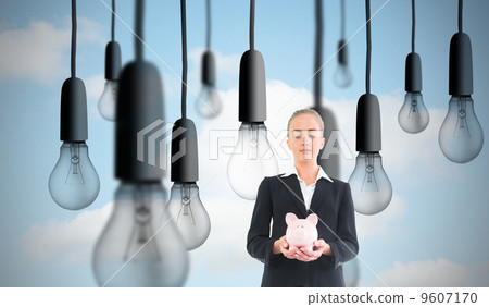 Composite image of businesswoman holding pink piggy bank Composite image of businesswoman holding pink piggy bank 9607170