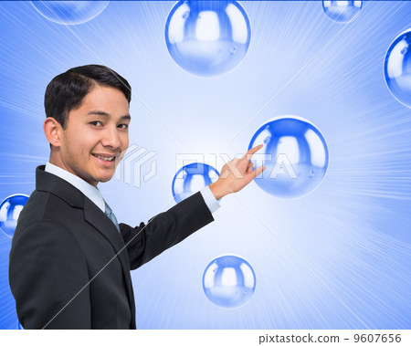 Composite image of smiling asian businessman pointing Composite image of smiling asian businessman pointing 9607656