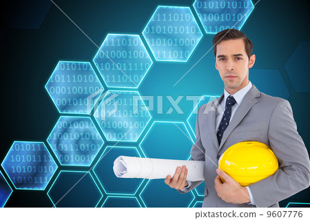 Composite image of serious architect holding plans and hard hat 9607776