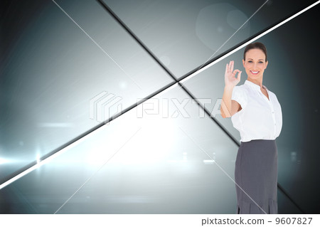 Composite image of elegant businesswoman showing an okay gesture Composite image of elegant businesswoman showing an okay gesture 9607827