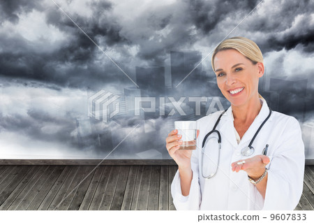 Composite image of happy doctor holding out pills and water glas Composite image of happy doctor holding out pills and water glas 9607833