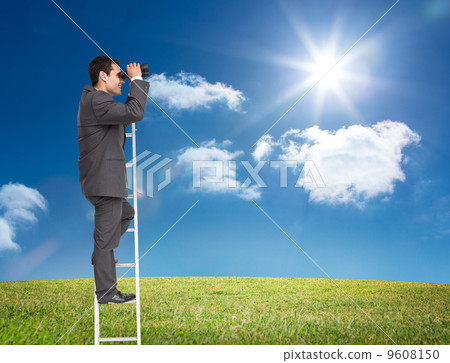 Composite image of businessman standing on ladder 9608150