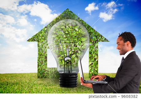 Composite image of businessman working on laptop Composite image of businessman working on laptop 9608382