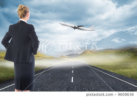 Composite image of businesswoman standing with hands on hips Composite image of businesswoman standing with hands on hips 9608636