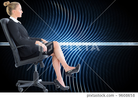 Composite image of businesswoman sitting on swivel chair in blac 9608658
