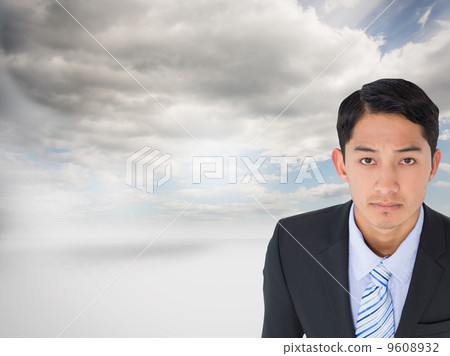 Composite image of serious asian businessman 9608932