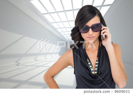 Composite image of serious elegant brunette wearing sunglasses o 9609031