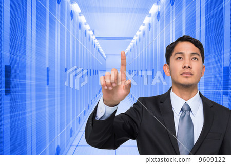Composite image of stern asian businessman pointing Composite image of stern asian businessman pointing 9609122