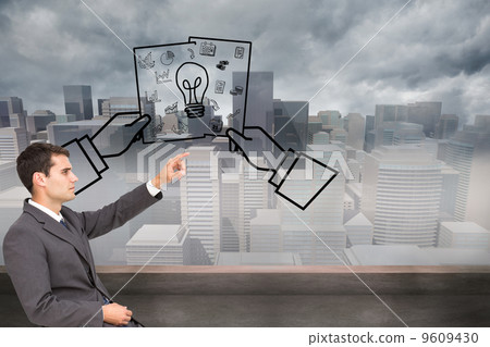 Composite image of businessman sitting and pointing the finger Composite image of businessman sitting and pointing the finger 9609430