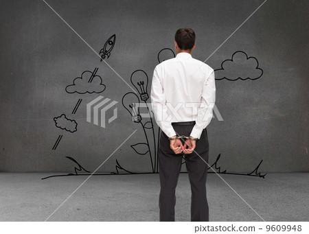Composite image of rear view of young businessman wearing handcu Composite image of rear view of young businessman wearing handcu 9609948