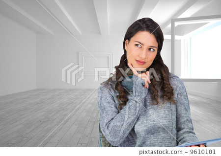 Composite image of pensive model wearing winter clothes holding Composite image of pensive model wearing winter clothes holding 9610101