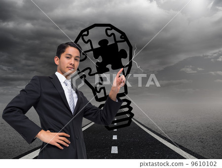 Composite image of unsmiling asian businessman pointing Composite image of unsmiling asian businessman pointing 9610102