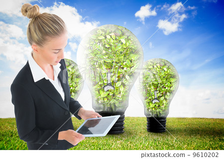 Composite image of businesswoman holding new tablet Composite image of businesswoman holding new tablet 9610202