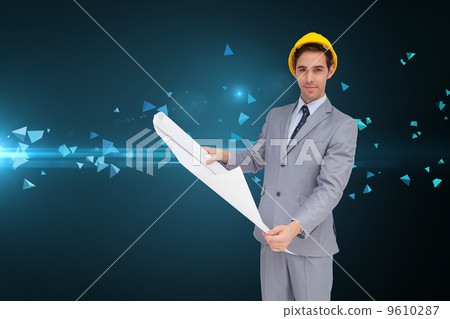Composite image of serious architect with hard hat holding plans Composite image of serious architect with hard hat holding plans 9610287