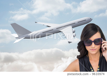Composite image of serious elegant brunette wearing sunglasses o Composite image of serious elegant brunette wearing sunglasses o 9610974