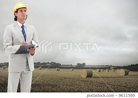 Composite image of architect taking notes Composite image of architect taking notes 9611560