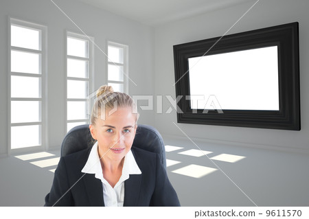 Composite image of businesswoman sitting on swivel chair with la Composite image of businesswoman sitting on swivel chair with la 9611570