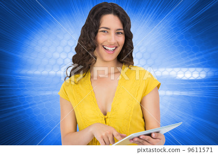 Composite image of smiling casual young woman scrolling on her t Composite image of smiling casual young woman scrolling on her t 9611571