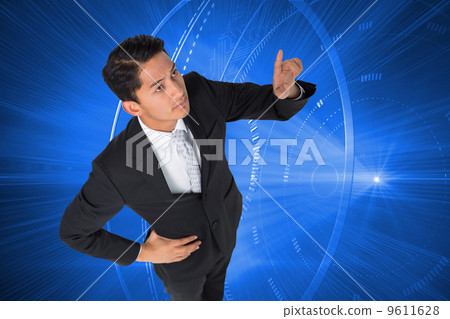 Composite image of unsmiling asian businessman pointing Composite image of unsmiling asian businessman pointing 9611628