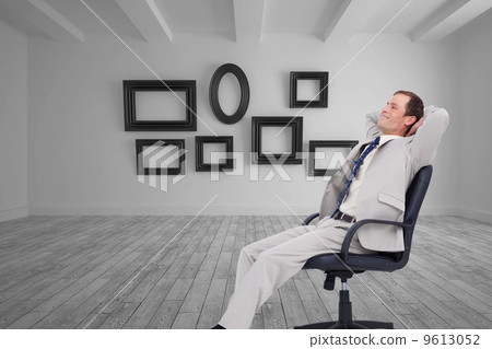 Composite image of side view of businessman leaning back in his Composite image of side view of businessman leaning back in his 9613052