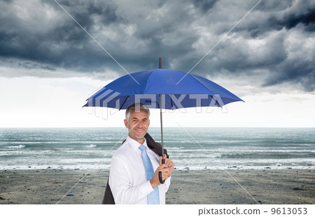 Composite image of businessman holding umbrella smiling at camer Composite image of businessman holding umbrella smiling at camer 9613053