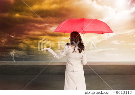 Composite image of businesswoman holding umbrella Composite image of businesswoman holding umbrella 9613113