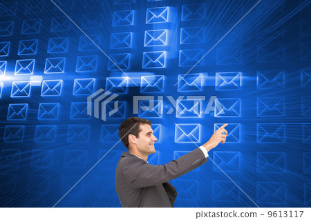 Composite image of smiling classy businessman sitting and pointi Composite image of smiling classy businessman sitting and pointi 9613117