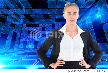Composite image of businesswoman standing with hands on hips 9613147